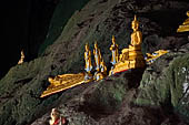 Luang Prabang, Laos - The Pak Ou Caves, the lower cave called Tham Ting. The caves, a Buddhist pilgrimage site, are a repository of old Buddha statues.